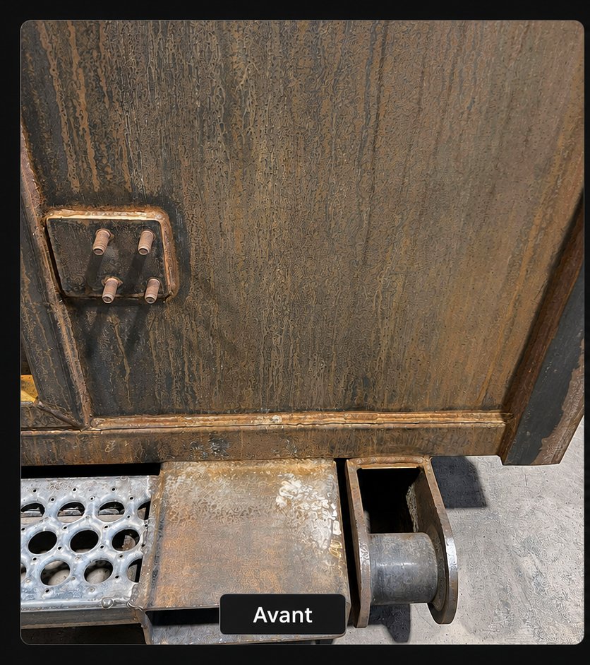 Close-up metal detail before laser restoration with heavy oxidation, streaking, and deposits around welds and mounting points